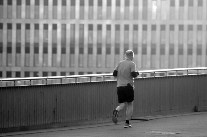 man running on bridge